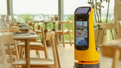 Robotic waiter in a restaurant setting with tables and chairs in the background